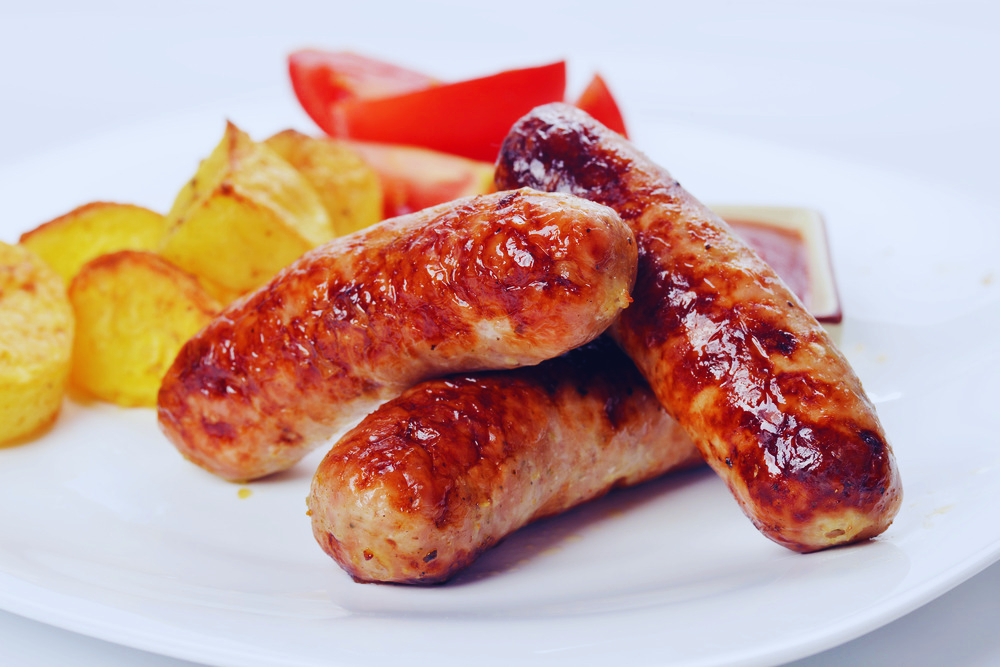 Delia chicken sausage links plated with roasted potatoes